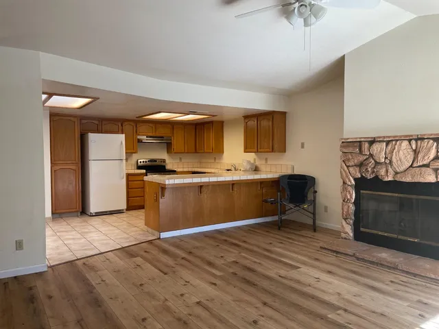 a kitchen with a sink appliances cabinets and a counter top space