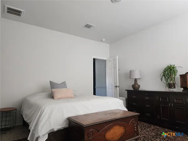 a bedroom with a bed and a dresser