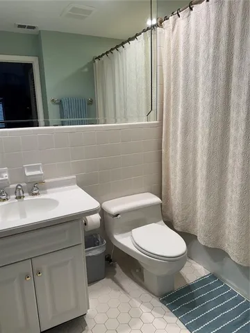 an aerial view of a house with a yard and lake view