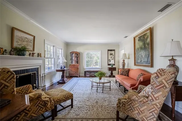 a living room with furniture large window and a fireplace