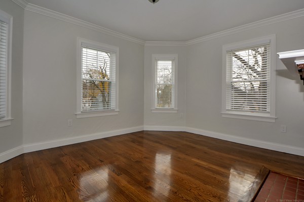 84 Maple Street, Unit 2 Boston, MA 02132 - Photo 13 of 15 a view of an empty room with wooden floor and a window