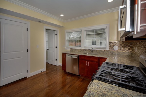 84 Maple Street, Unit 2 Boston, MA 02132 - Photo 8 of 15 a kitchen with granite countertop a stove and a sink