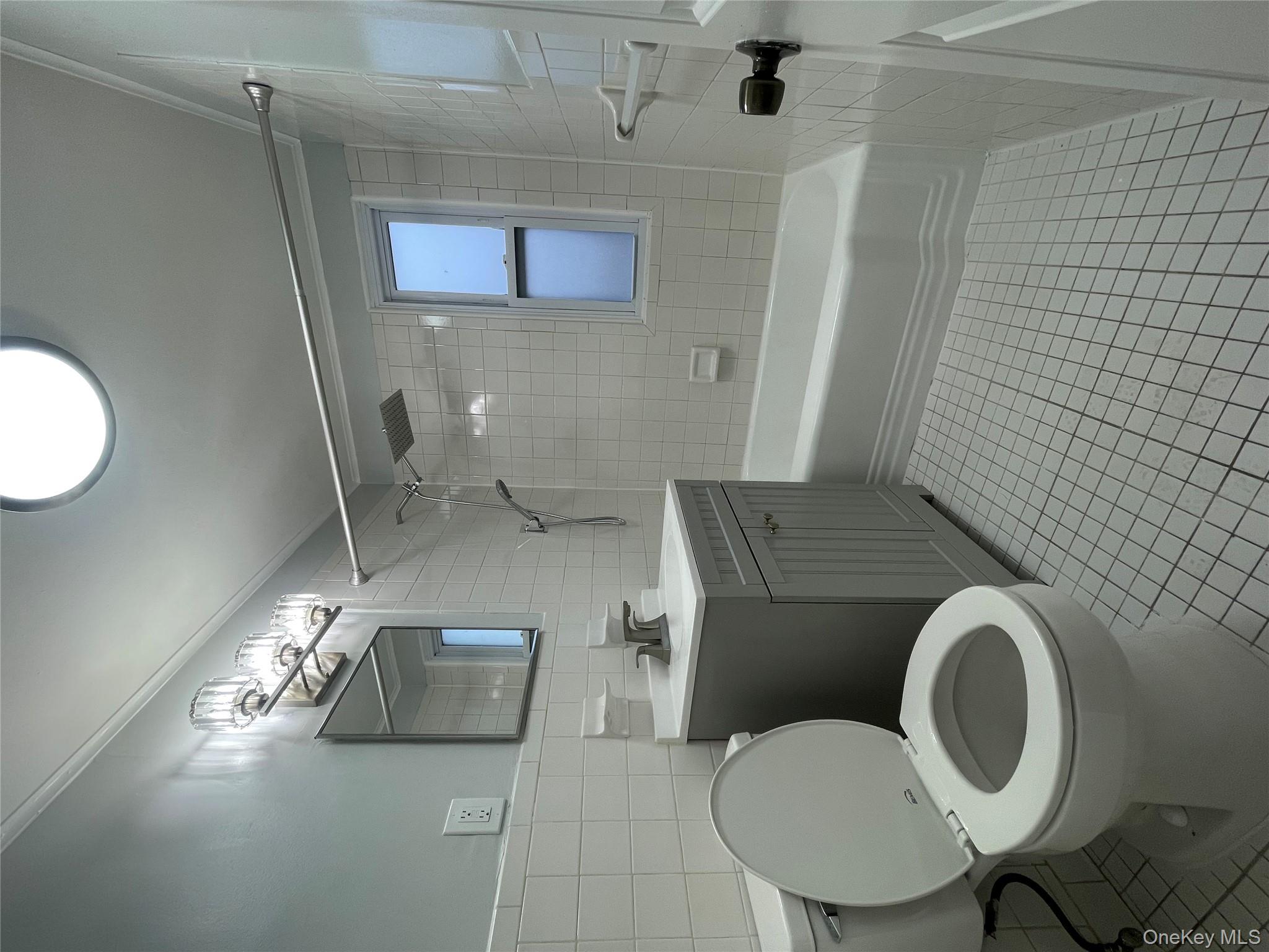 129-38 154th Street Queens, NY 11434 - Photo 2 of 10 a bathroom with a sink a toilet and bathtub