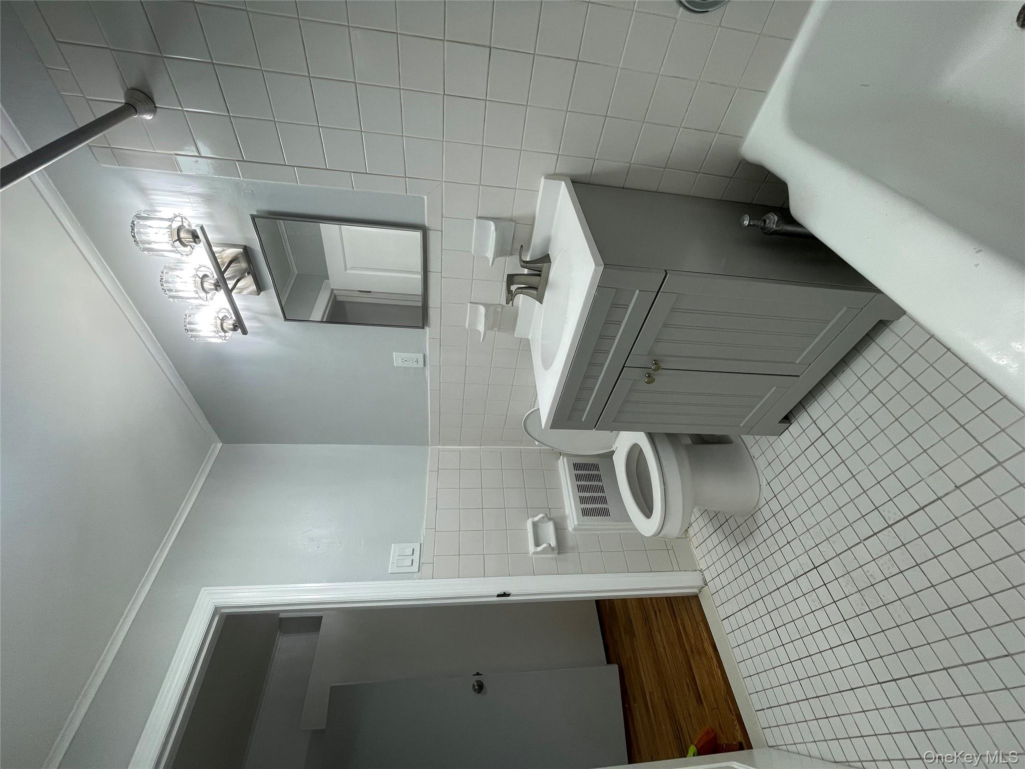 129-38 154th Street Queens, NY 11434 - Photo 3 of 10 a bathroom with a sink a toilet and shower