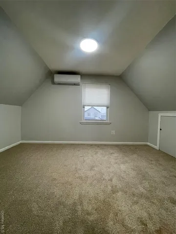 a view of an empty room and a window