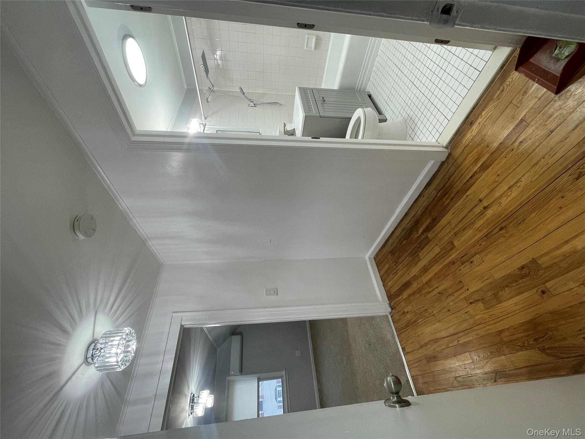 129-38 154th Street Queens, NY 11434 - Photo 6 of 10 a view of a room with wooden floor and a bathroom