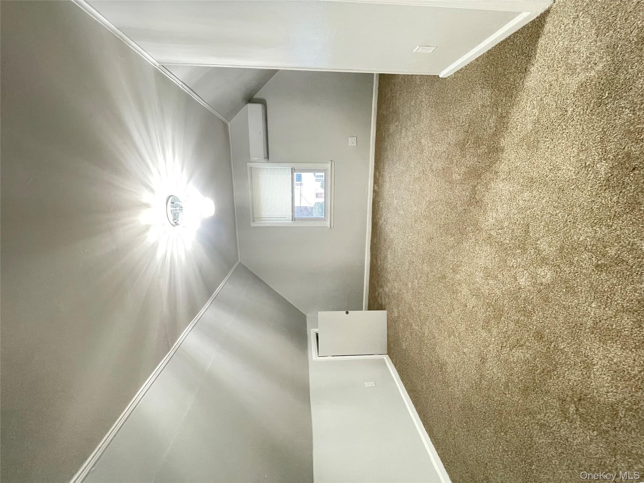 129-38 154th Street Queens, NY 11434 - Photo 8 of 10 an empty room with a empty space and windows