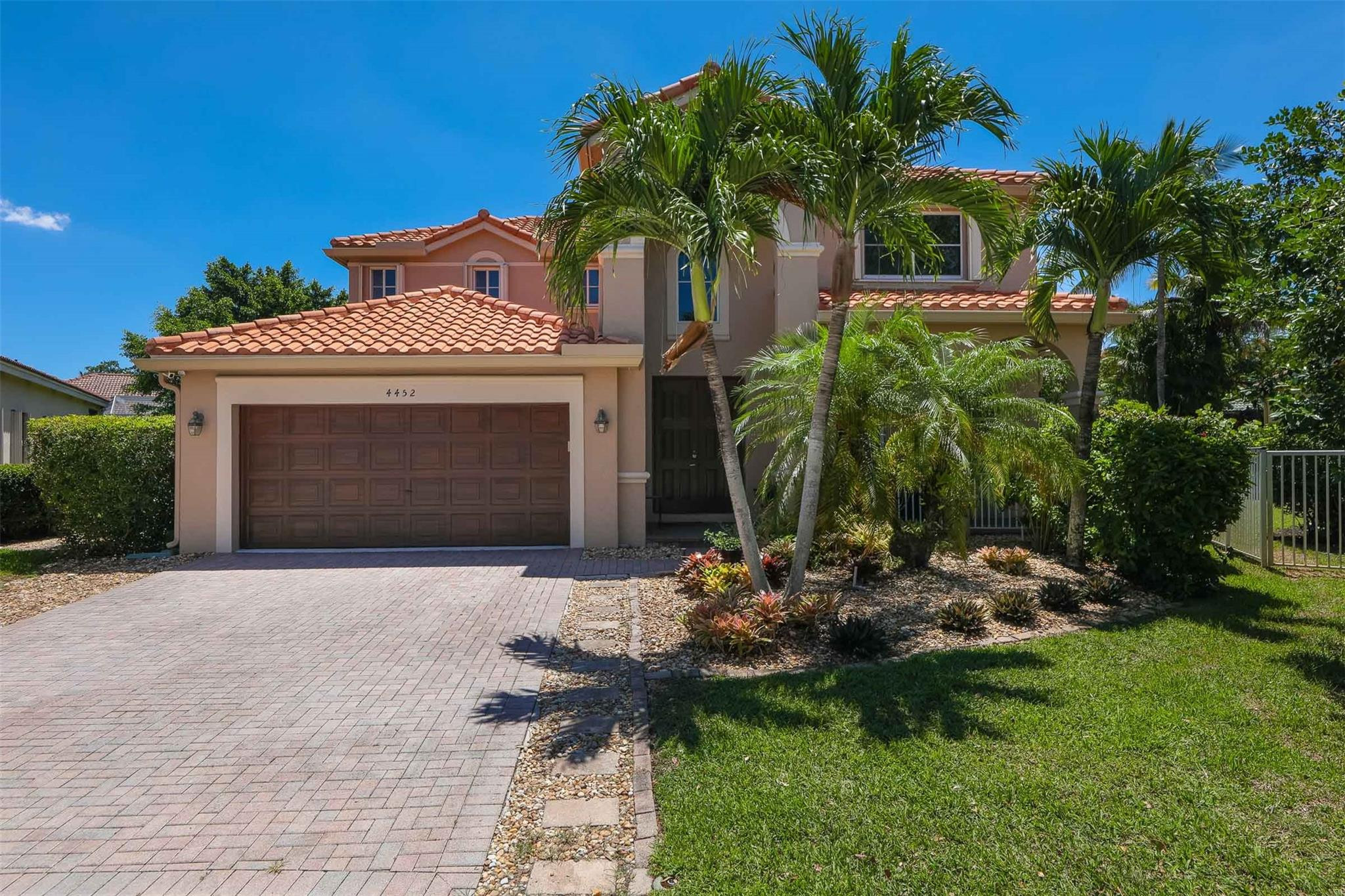 4452 Stone Ridge Way Weston, FL 33331 - Photo 2 of 65 a front view of a house with a yard