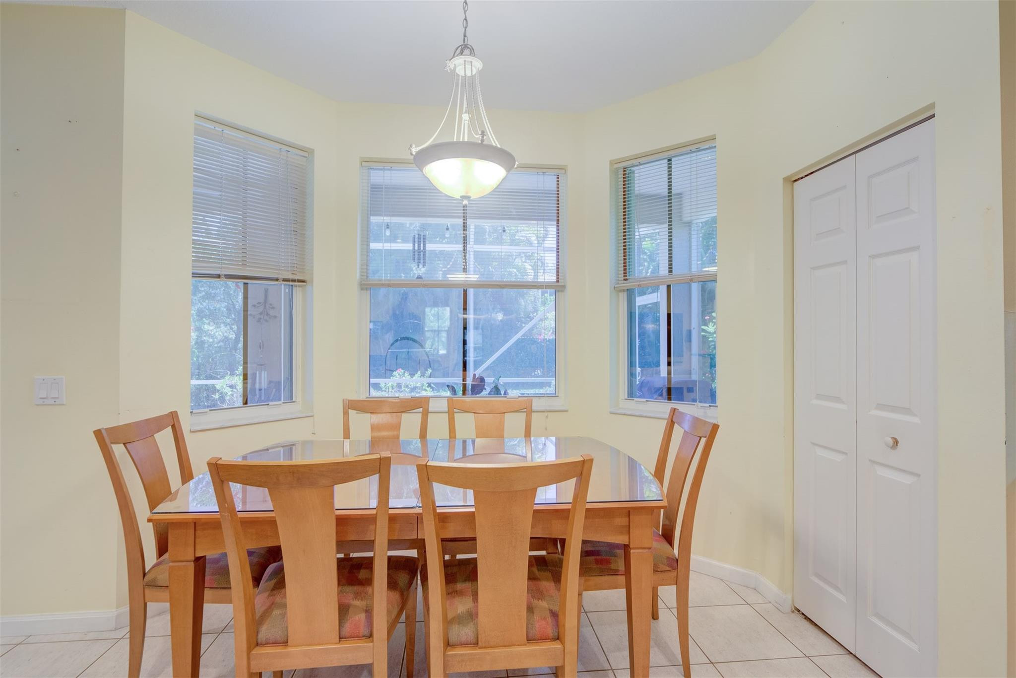 4452 Stone Ridge Way Weston, FL 33331 - Photo 32 of 65 a view of a dining room with furniture and wooden floor
