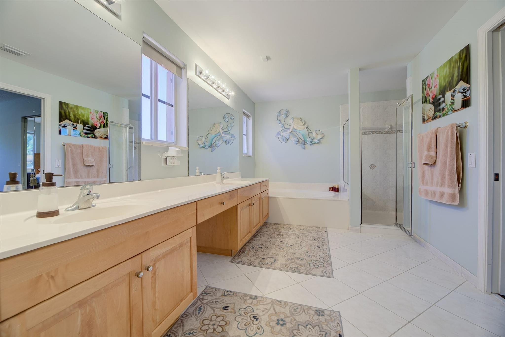 4452 Stone Ridge Way Weston, FL 33331 - Photo 40 of 65 a spacious bathroom with a double vanity sink a mirror a bathtub and toilet