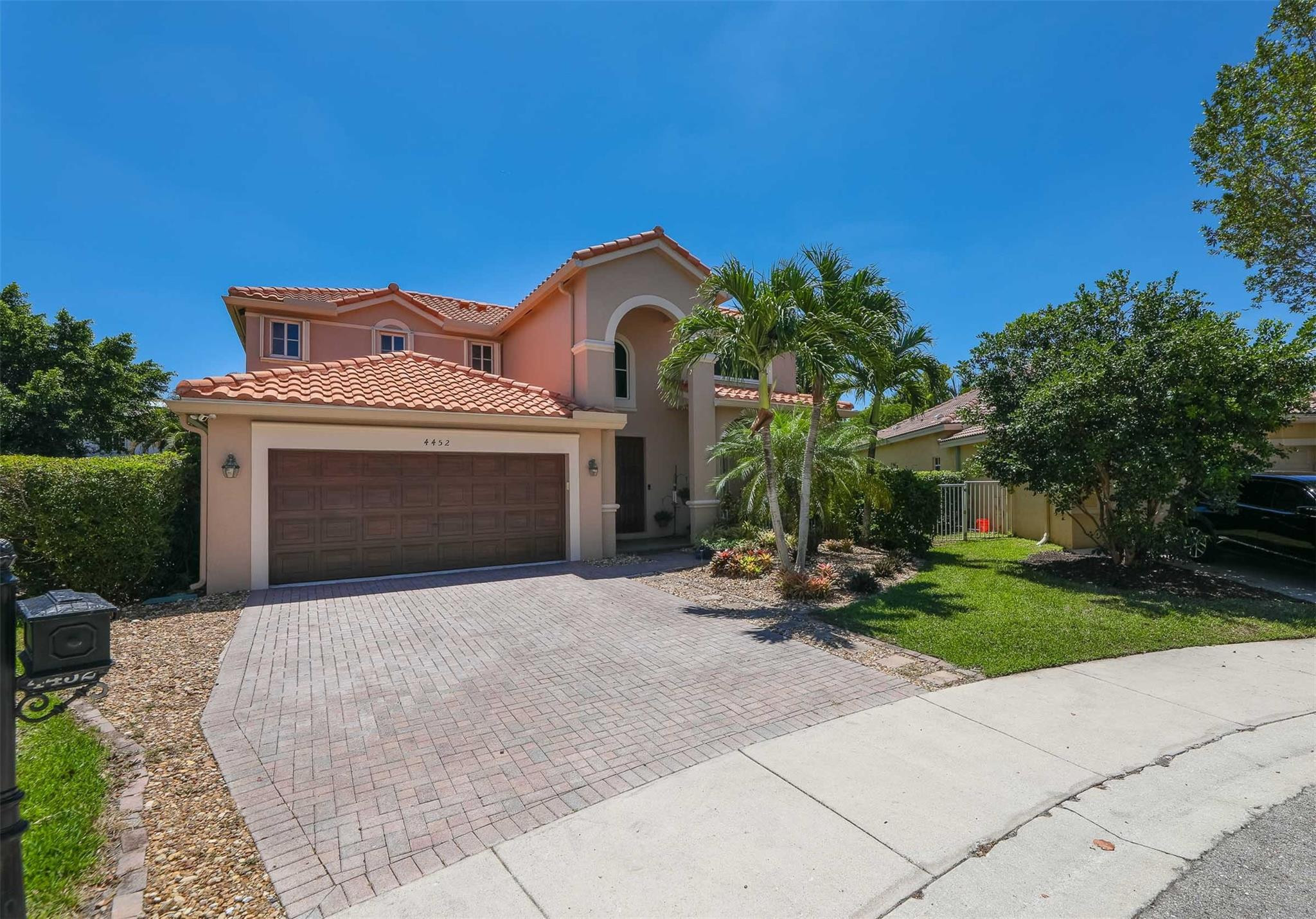 4452 Stone Ridge Way Weston, FL 33331 - Photo 4 of 65 a front view of a house with garden