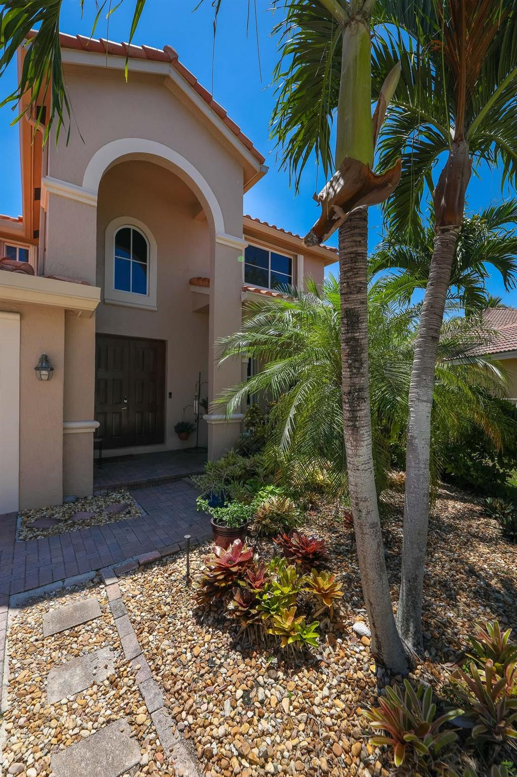 4452 Stone Ridge Way Weston, FL 33331 - Photo 5 of 65 a front view of a house with a yard
