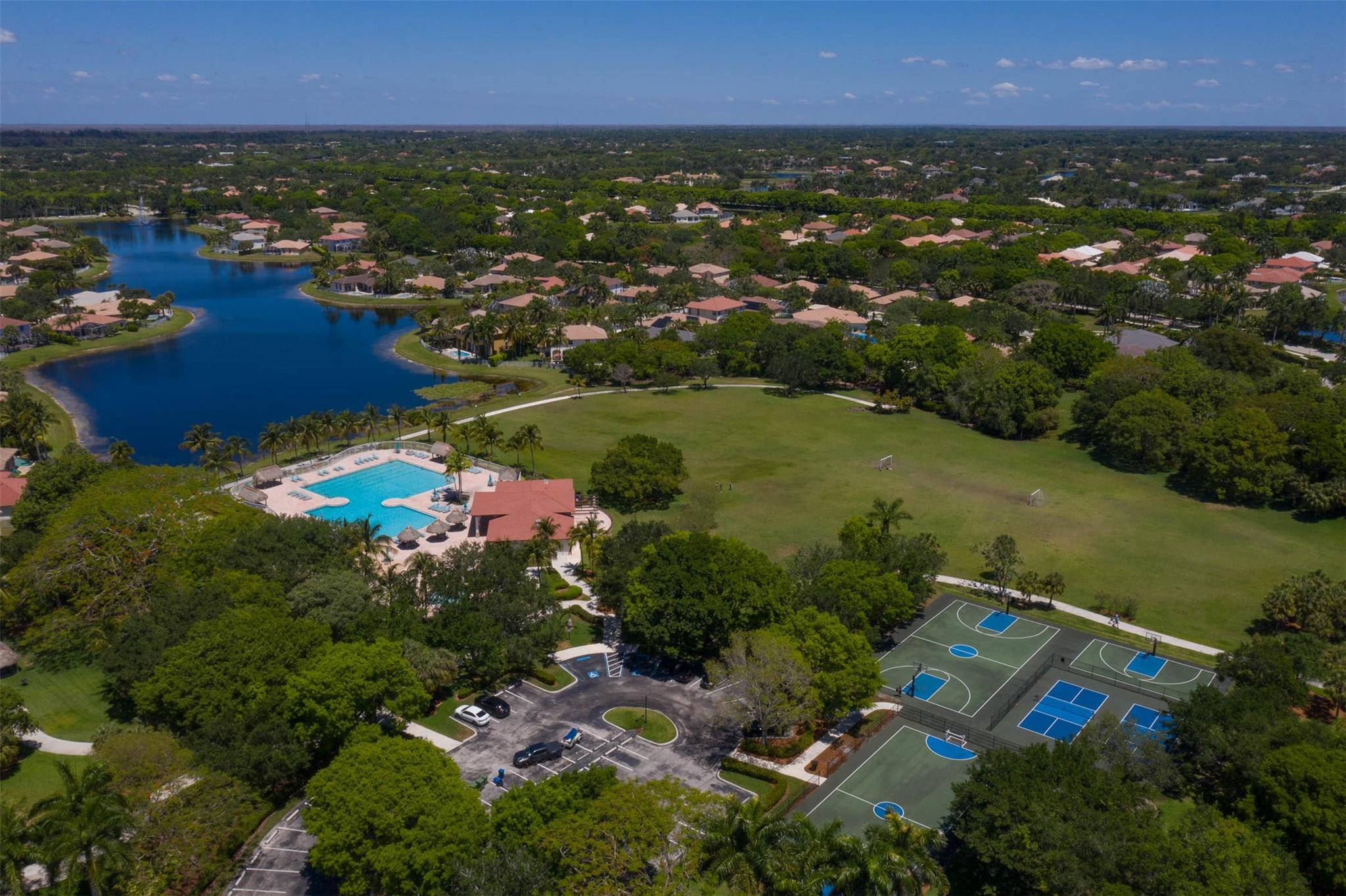 4452 Stone Ridge Way Weston, FL 33331 - Photo 61 of 65 an aerial view of residential houses with outdoor space and trees
