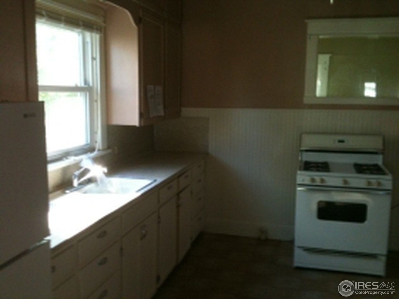 127 Platte Street Sterling, CO 80751 - Photo 2 of 4 a kitchen with a stove and a window