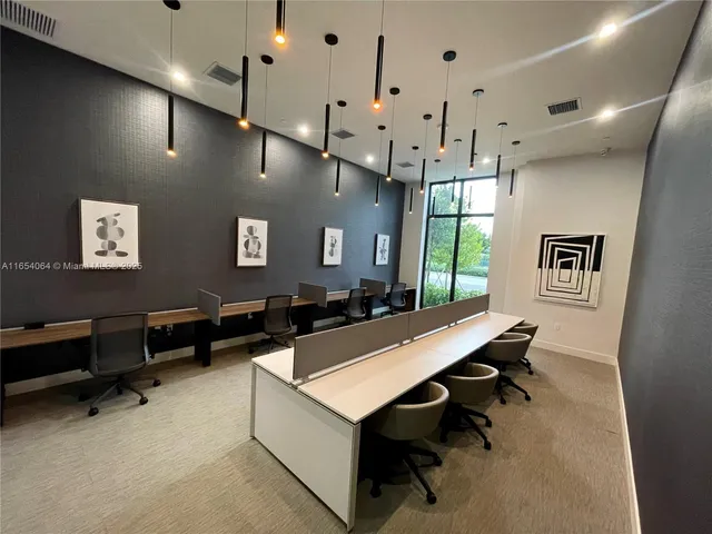 a room with pool table and window