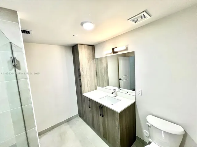a bathroom with a sink a toilet and mirror