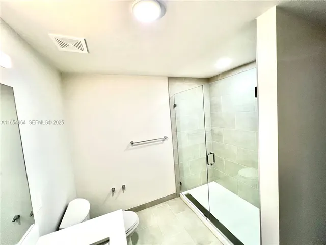 a bathroom with a shower and a toilet