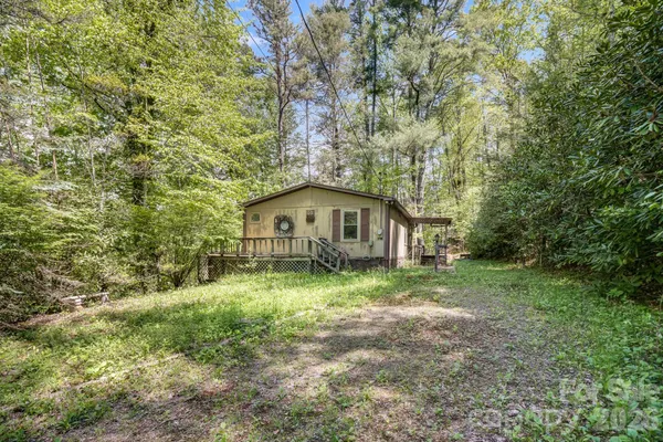 a yellow house in middle of the forest