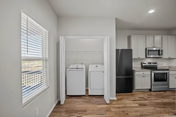 a view of an empty room with staircase