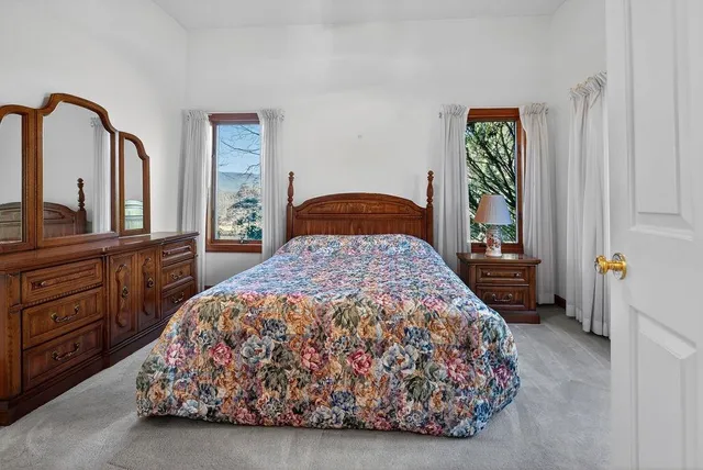 a room with a bed and a dresser