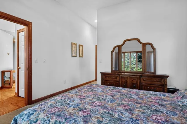 a bathroom with a granite countertop sink a large mirror and a window