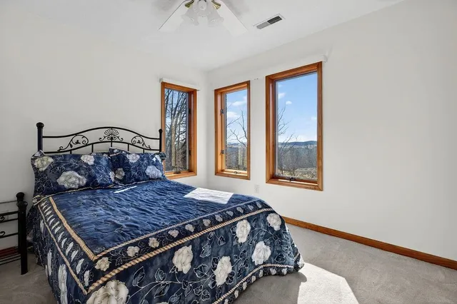 a bedroom with a bed and a table