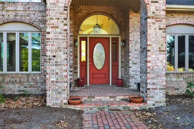 a view of a entryway with a floor to ceiling window and front door