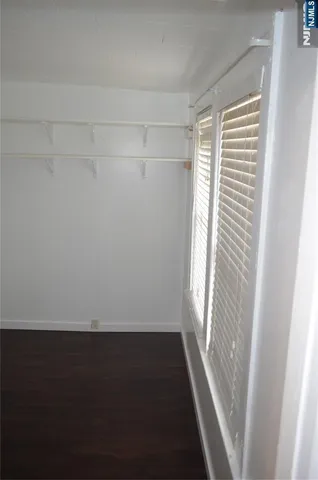 a view of a room with wooden floor