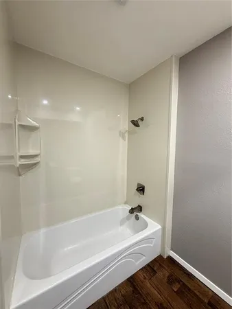a bathroom with a bathtub and a sink