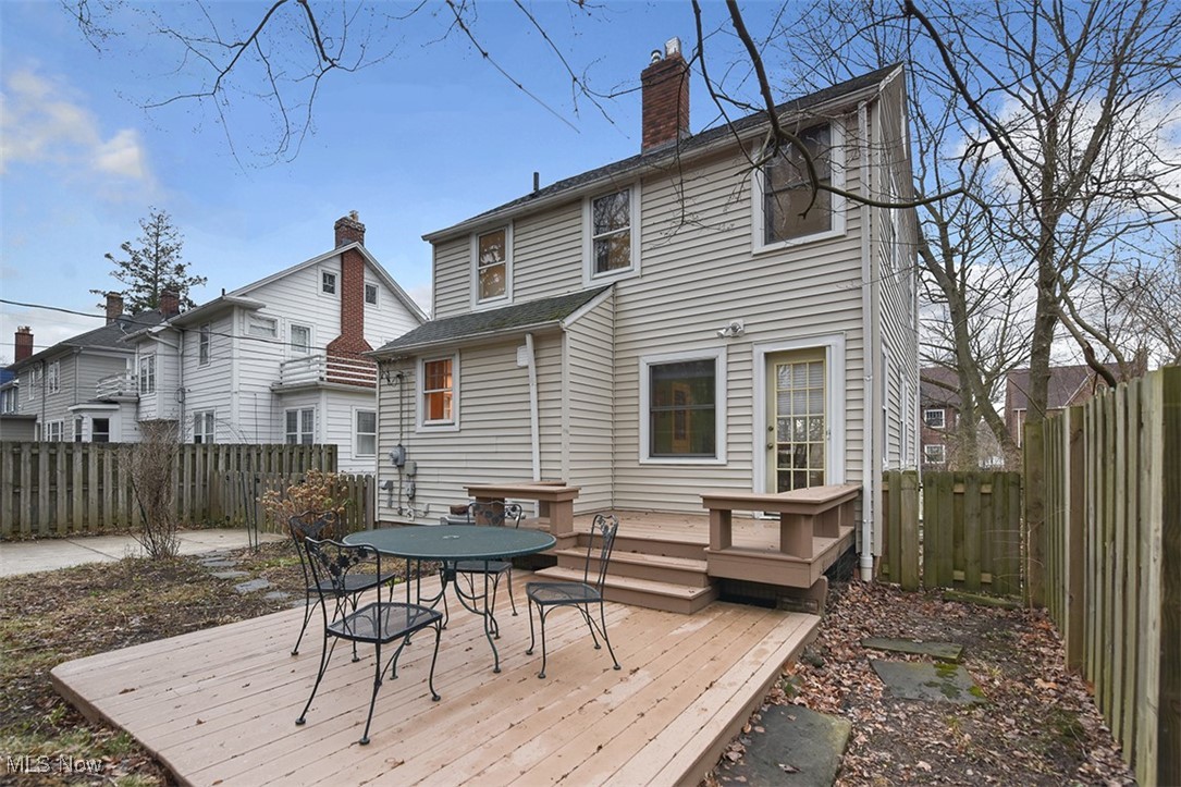 2469 Queenston Road Cleveland, OH 44118 - Photo 35 of 37 Back of property with a fenced backyard, a deck, a chimney, and outdoor dining space