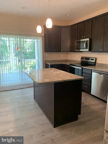 a kitchen with a stove a sink and a microwave