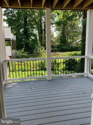 a view of a wooden deck with a yard