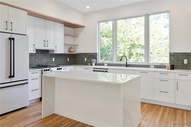 a kitchen with a sink stove and cabinets