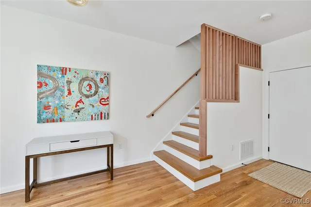 a view of entryway with stairs and wooden floor