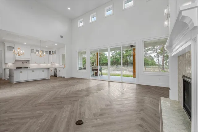 a view of an empty room with a fireplace and a window