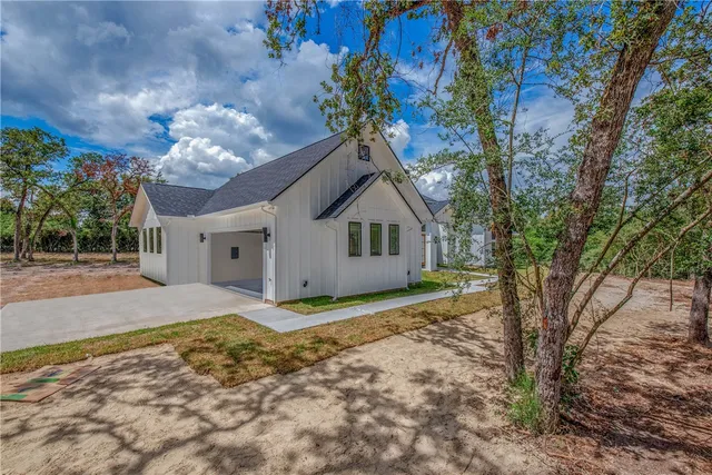 a house that has a tree in front of it