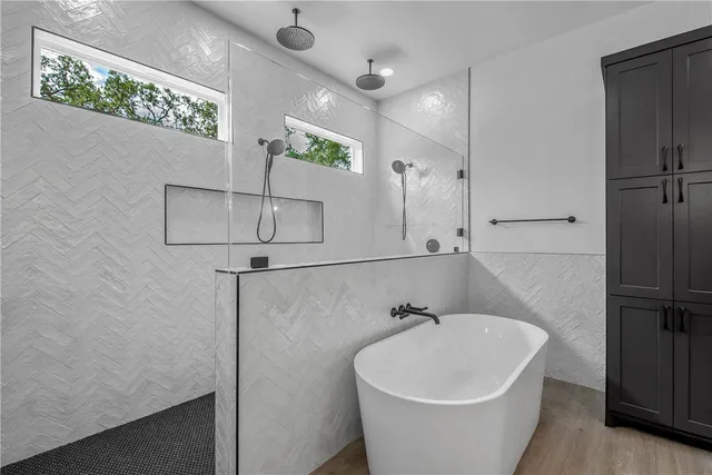 a bathroom with a sink double vanity and tub