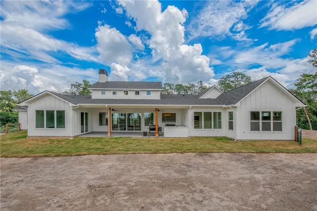 a view of a house with backyard porch and sitting area