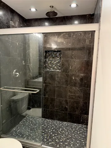 a bathroom with a shower and a sink