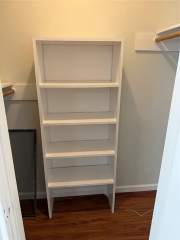 a view of walk in closet with empty racks