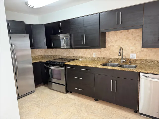 a kitchen with a sink stove and refrigerator