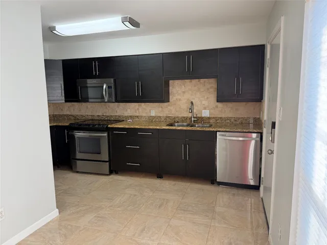 a kitchen with a sink and a stove