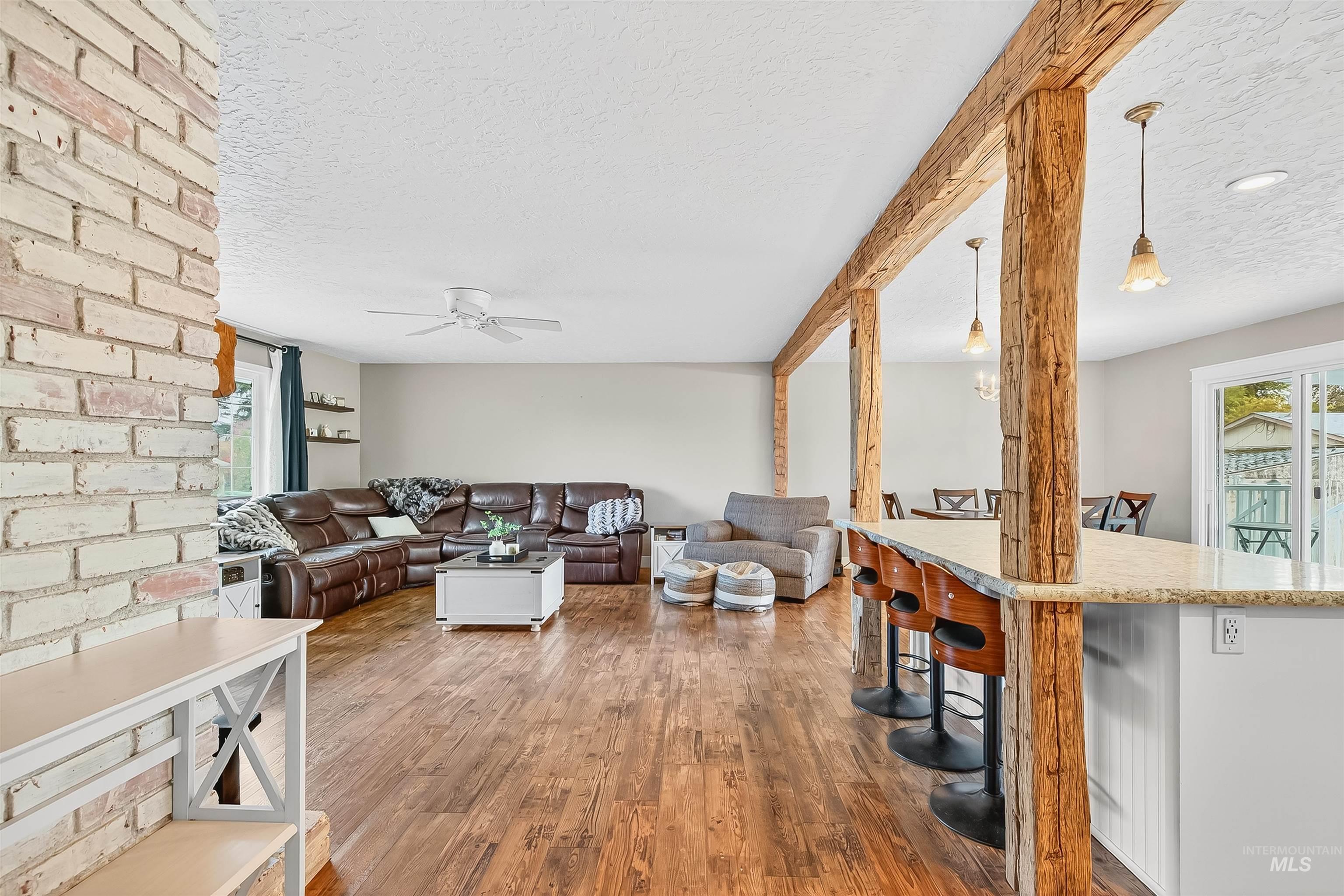 1220 Birch Avenue Lewiston, ID 83501 - Photo 12 of 45 Living area featuring a textured ceiling, wood finished floors, and a ceiling fan