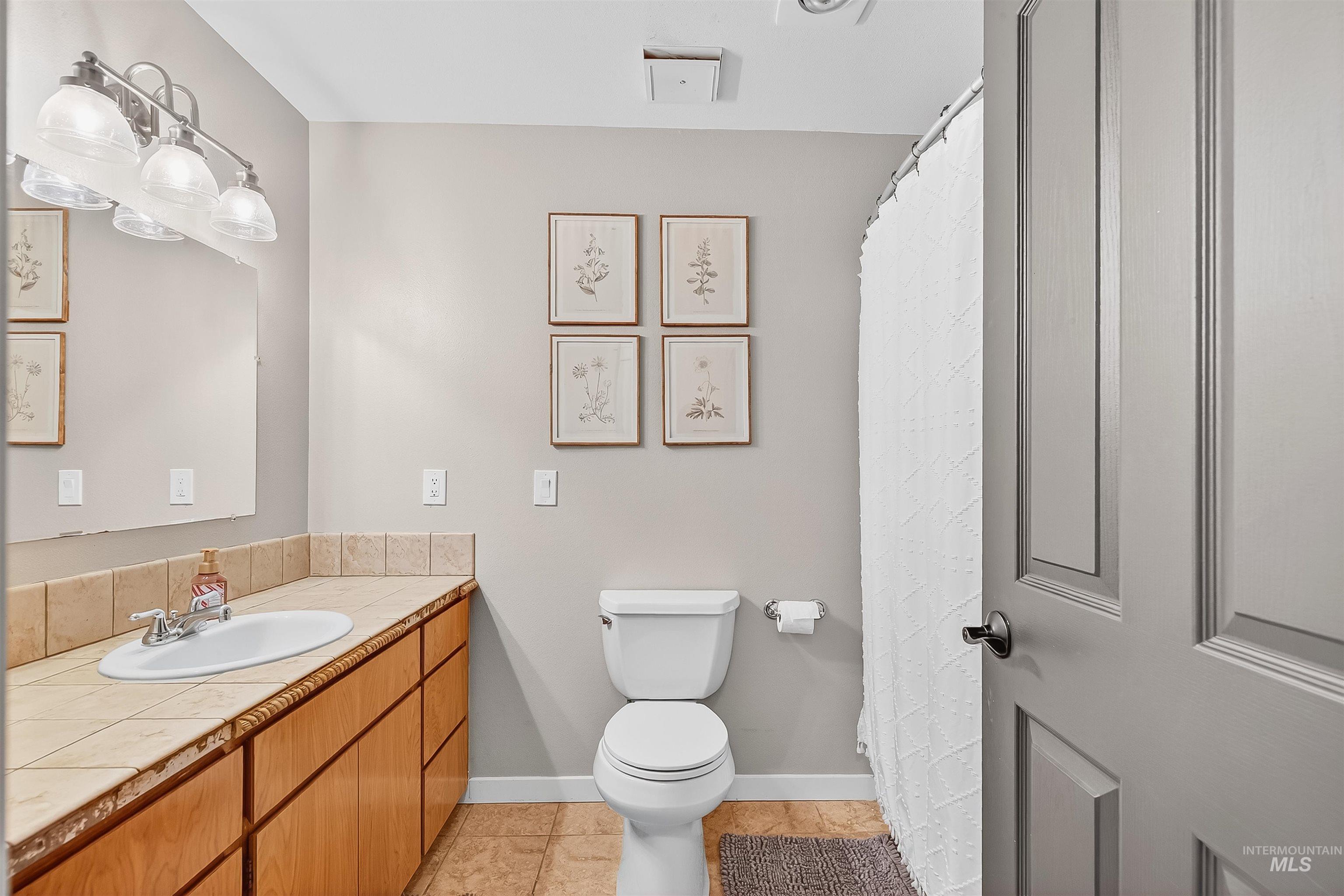1220 Birch Avenue Lewiston, ID 83501 - Photo 16 of 45 Full bath featuring light tile patterned floors, vanity, and a shower with shower curtain