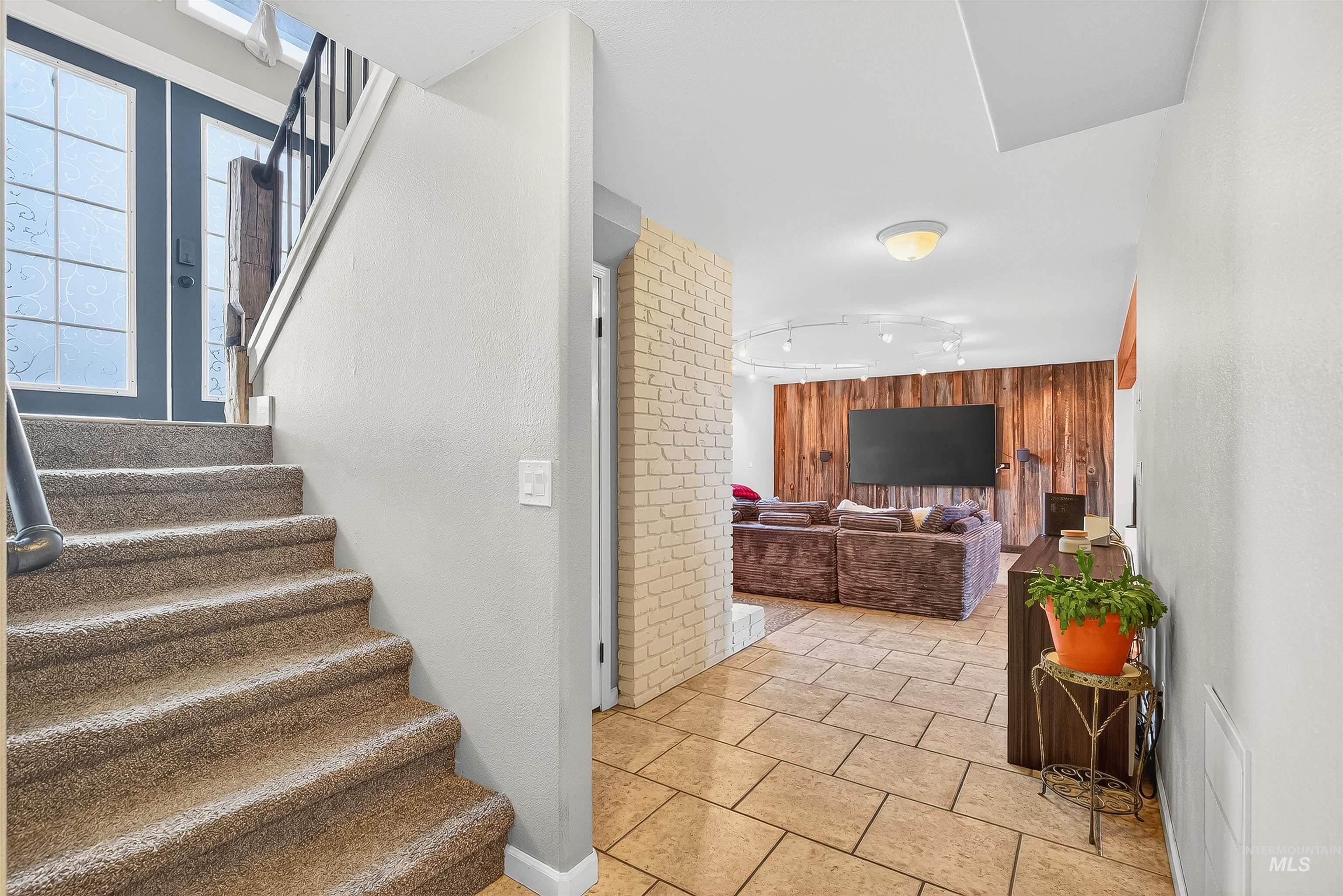 1220 Birch Avenue Lewiston, ID 83501 - Photo 21 of 45 Stairs with wood walls and tile patterned flooring