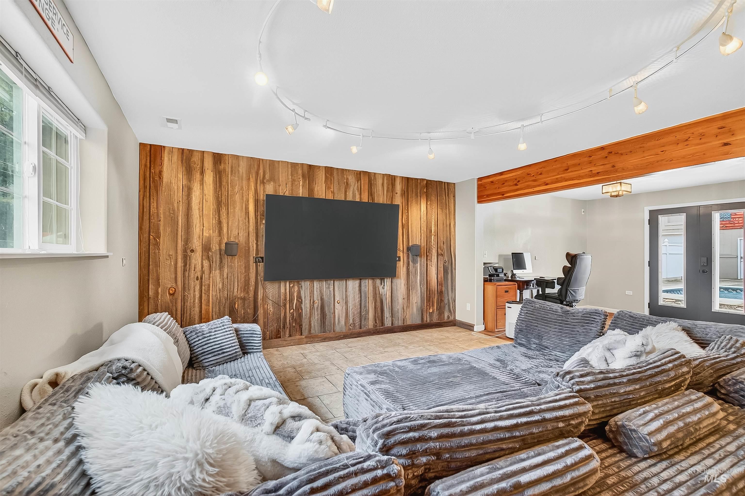 1220 Birch Avenue Lewiston, ID 83501 - Photo 23 of 45 Living area with wooden walls, a desk, and an accent wall