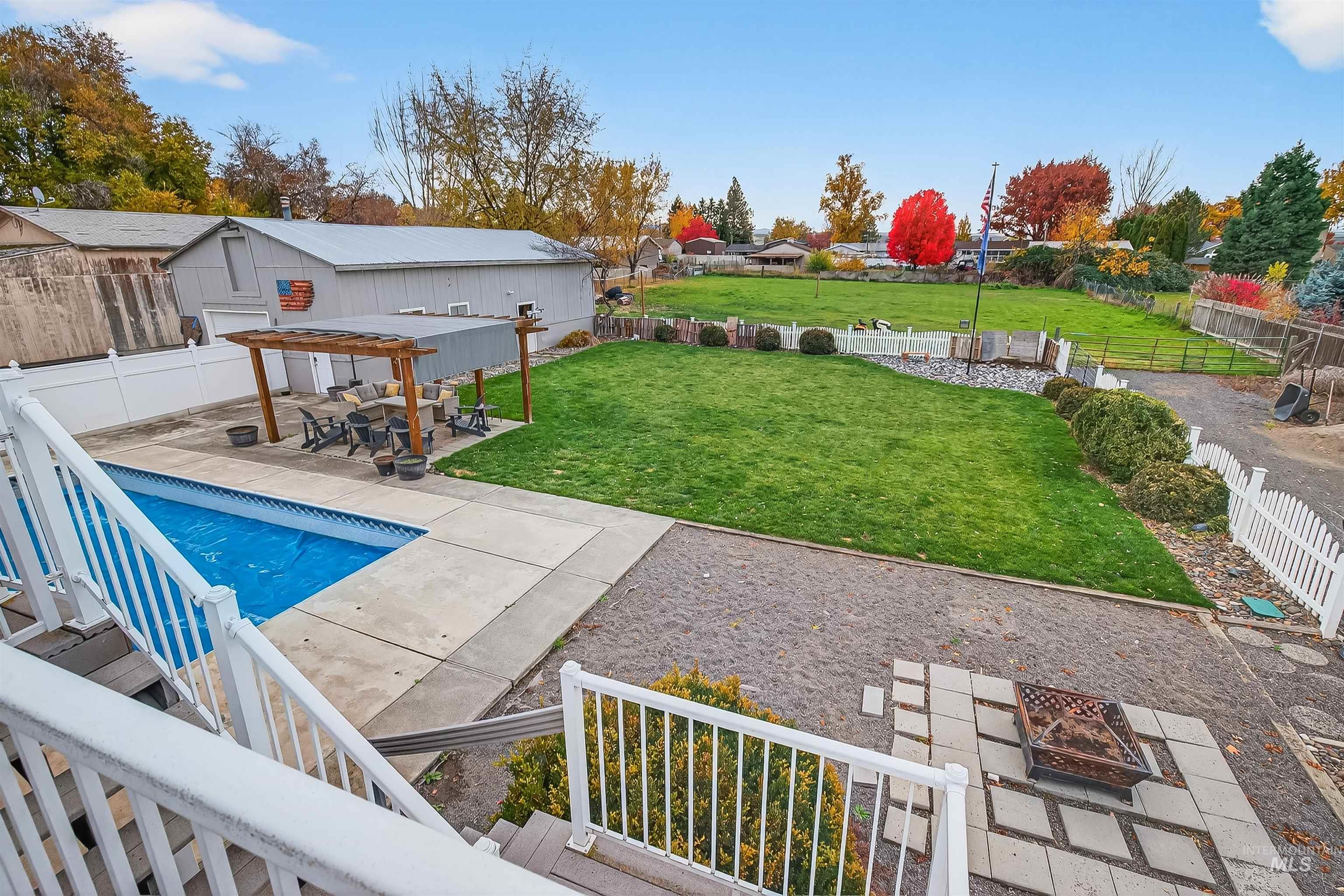 1220 Birch Avenue Lewiston, ID 83501 - Photo 36 of 45 Fenced backyard with a patio area, a fire pit, and a pergola