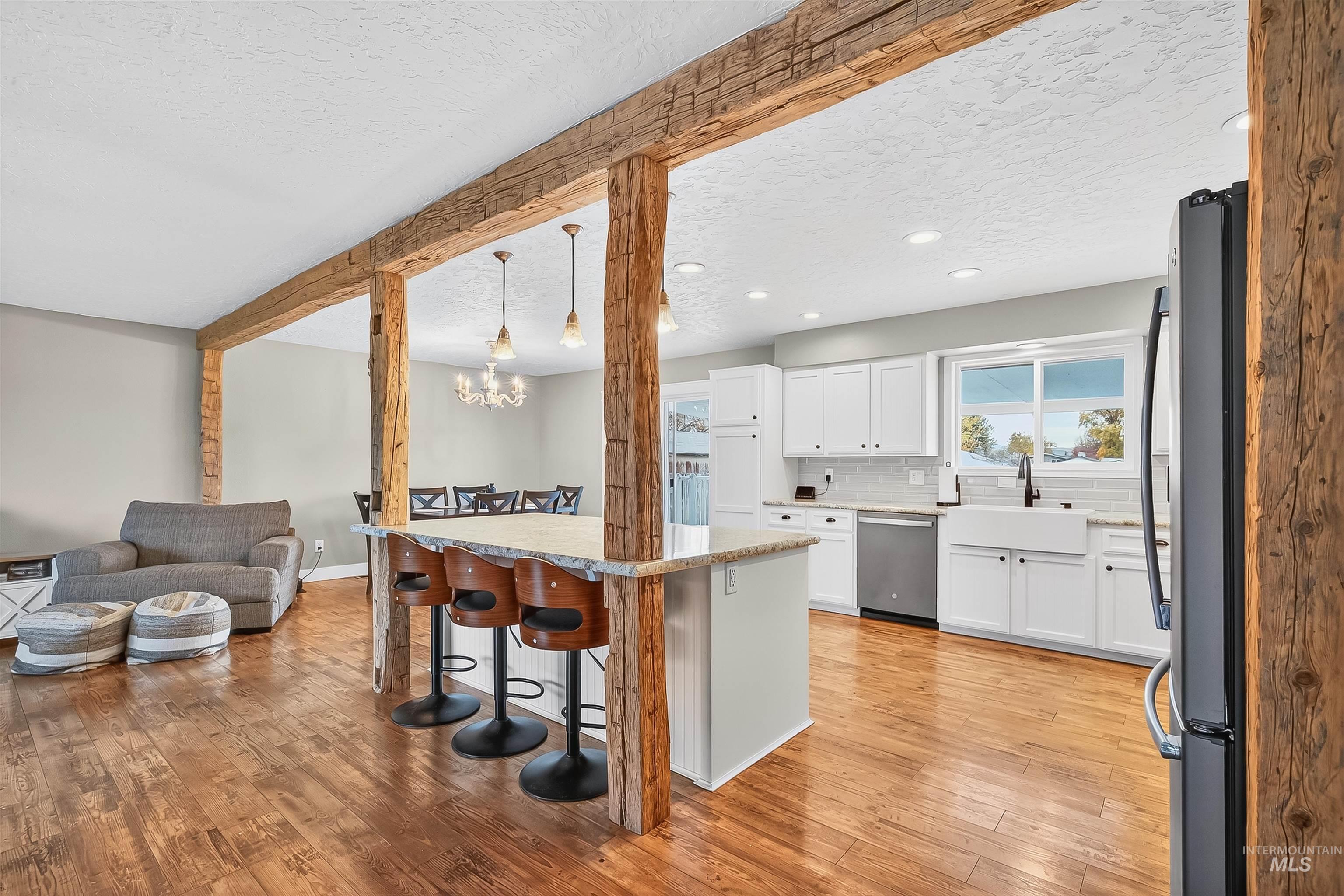 1220 Birch Avenue Lewiston, ID 83501 - Photo 44 of 45 Kitchen with a kitchen breakfast bar, open floor plan, white cabinets, appliances with stainless steel finishes, and light wood-style floors