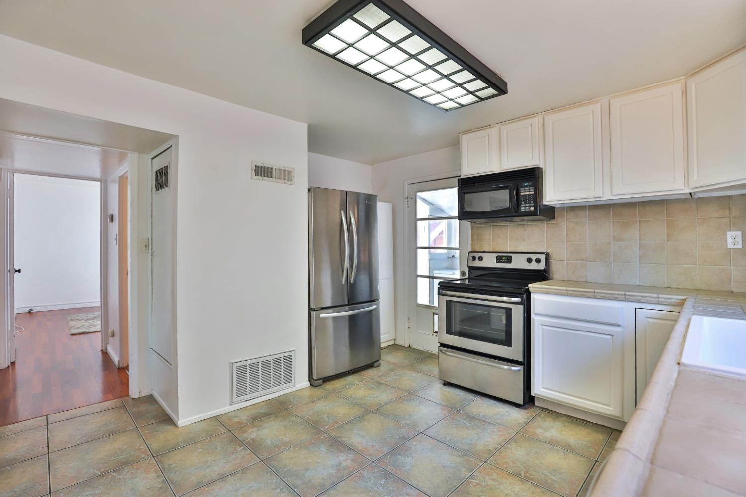 207 Peek Street Jackson, CA 95642 - Photo 11 of 30 a kitchen with stainless steel appliances a stove microwave and a refrigerator