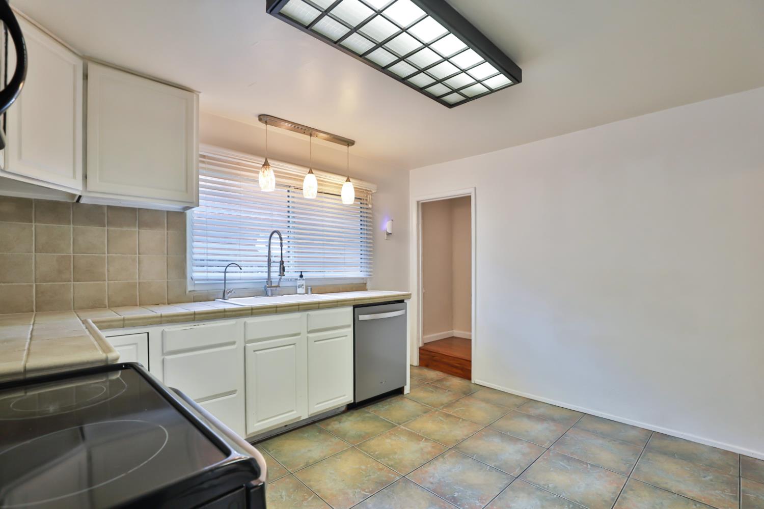 207 Peek Street Jackson, CA 95642 - Photo 12 of 30 a kitchen with stainless steel appliances a sink and cabinets